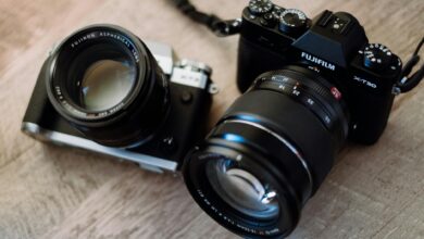 black and gray slr camera and black fujifilm dslr camera