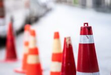 An orange traffic cone is placed on the road.