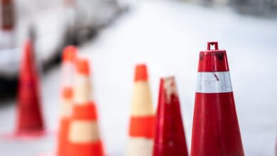 An orange traffic cone is placed on the road.