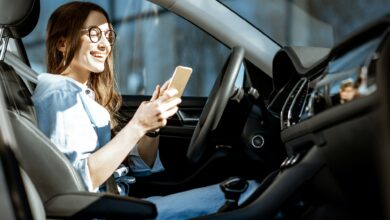 Woman with phone in the car